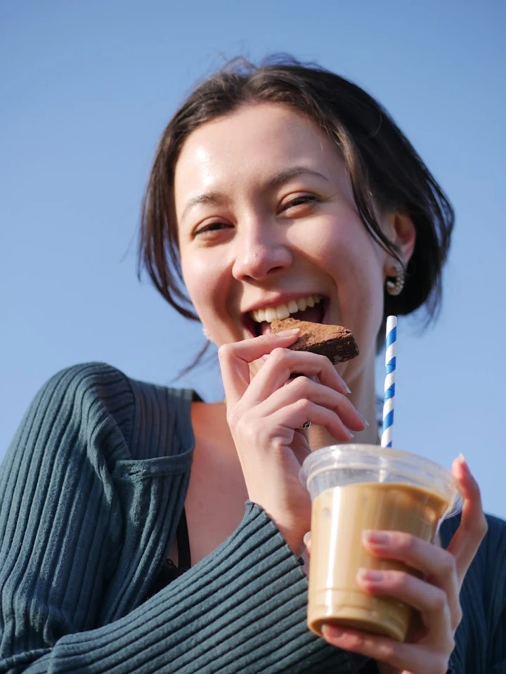 Happy person eating brownie